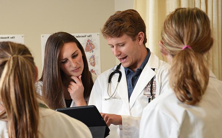 Students looking over a medical chart